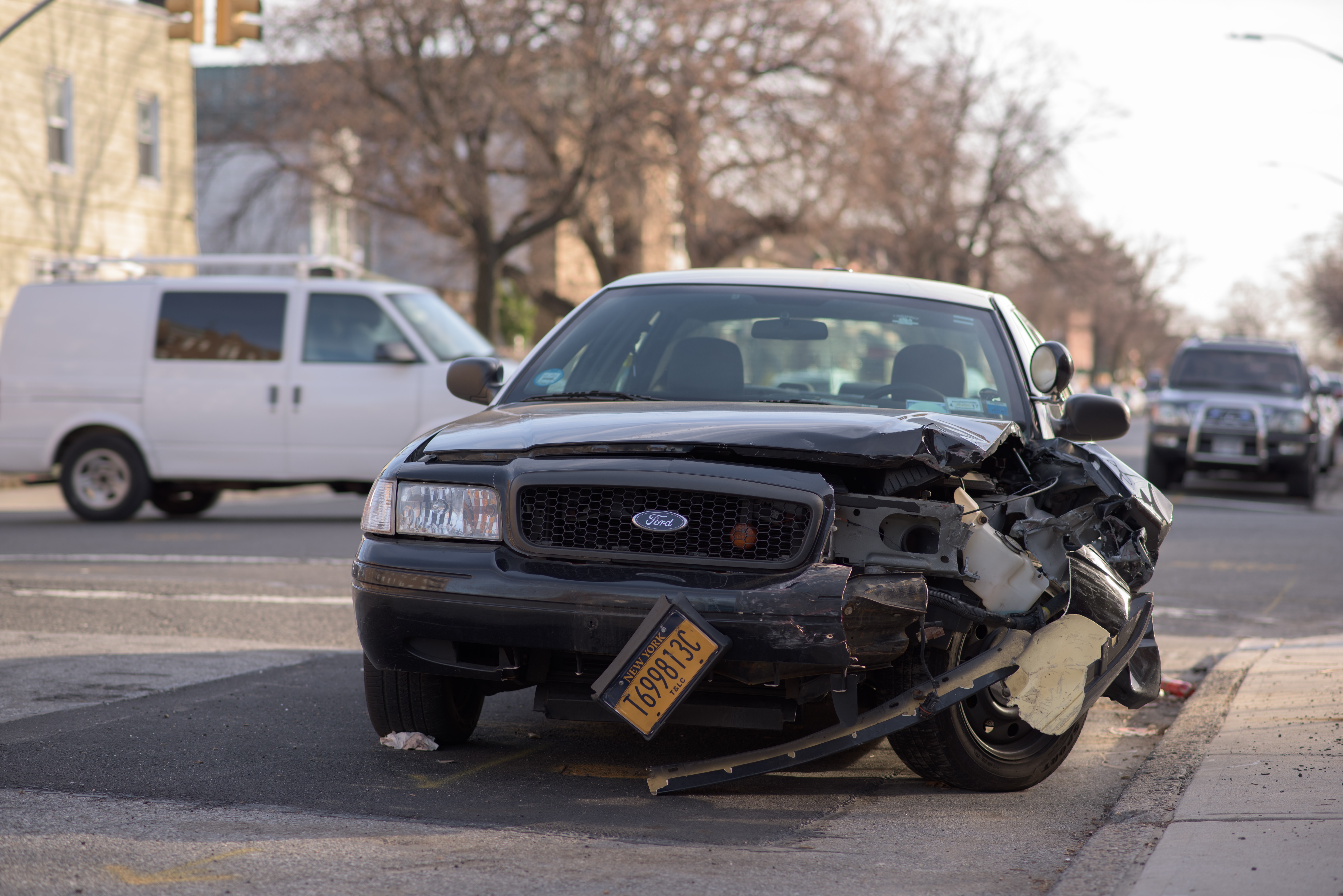A police car with its front end smashed up.