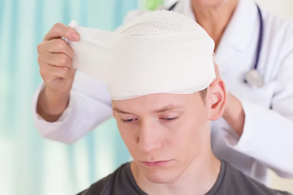 A person with a head wrapped in paper