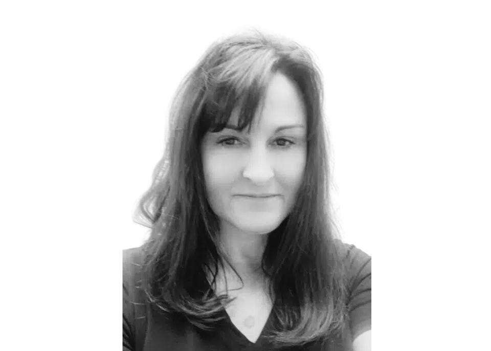 A black and white photo of a woman with long hair.