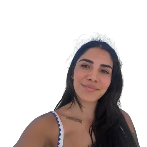 Smiling woman with tattoo on shoulder.